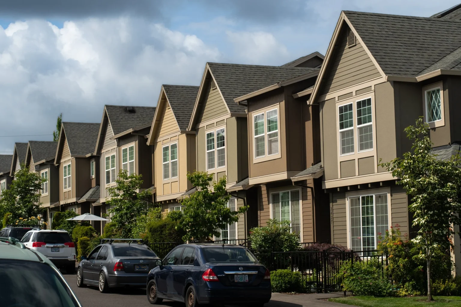 Row of multi-unit townhomes with freshly painted exteriors and trim